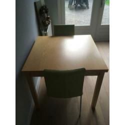 Uitschuifbare eettafel (Ikea Bjursta) en 2 leren stoelen